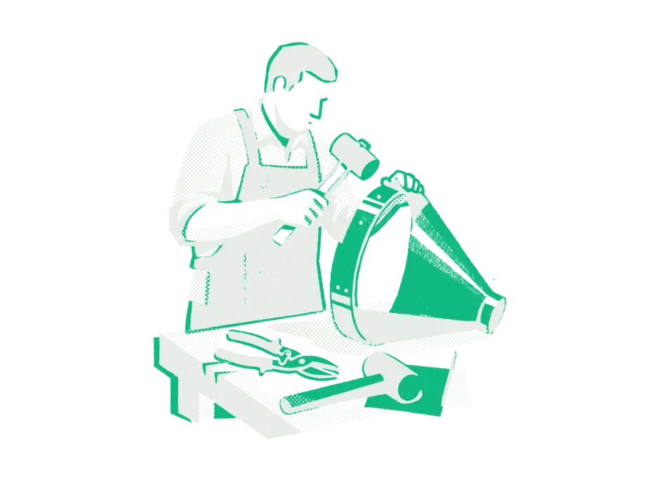 A craftsperson in an apron hammering an emerald band onto a large sheet-metal funnel at a workbench