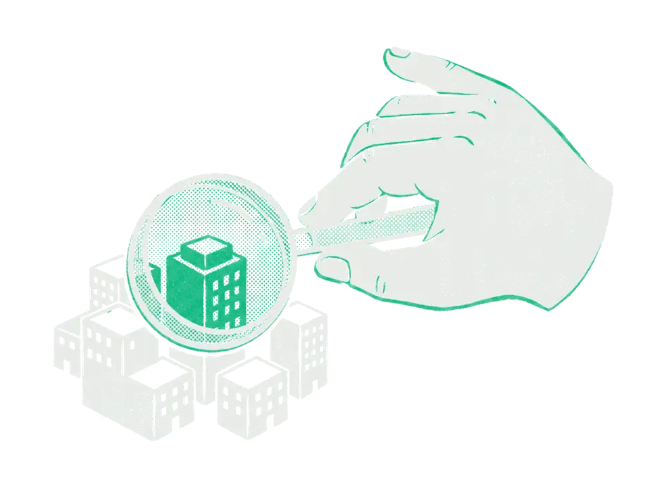 A giant hand holding a magnifying glass over a model town of black buildings, the one under the glass emerald