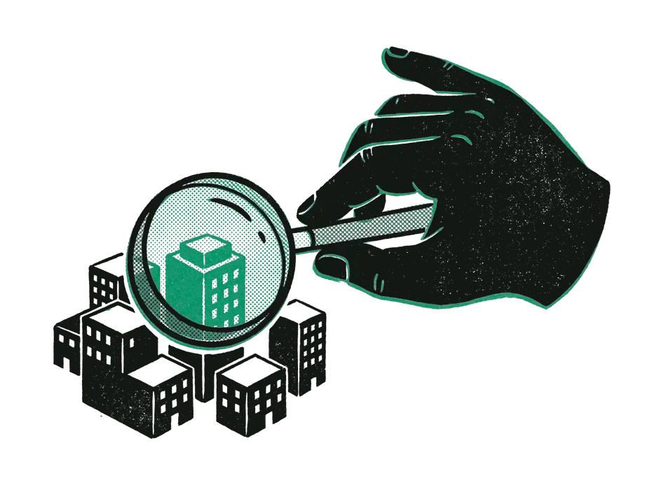 A giant hand holding a magnifying glass over a model town of black buildings, the one under the glass emerald