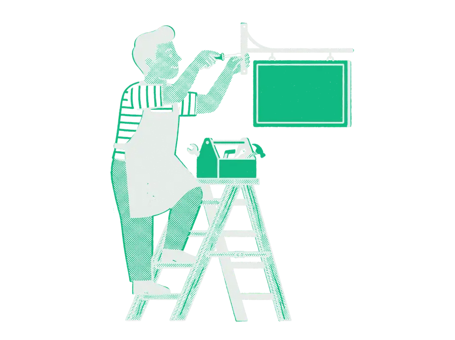 A shop owner on a stepladder fixing the bracket of a blank emerald sign, a toolbox open on the top step