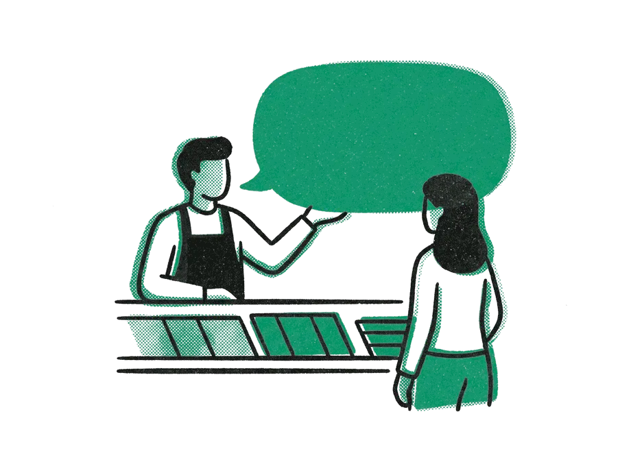 A shopkeeper in an apron handing a large emerald speech bubble across the counter to a customer