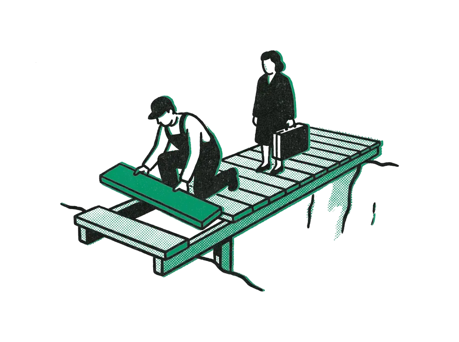 A worker laying an emerald plank at the unfinished end of a footbridge while a traveler waits with a suitcase